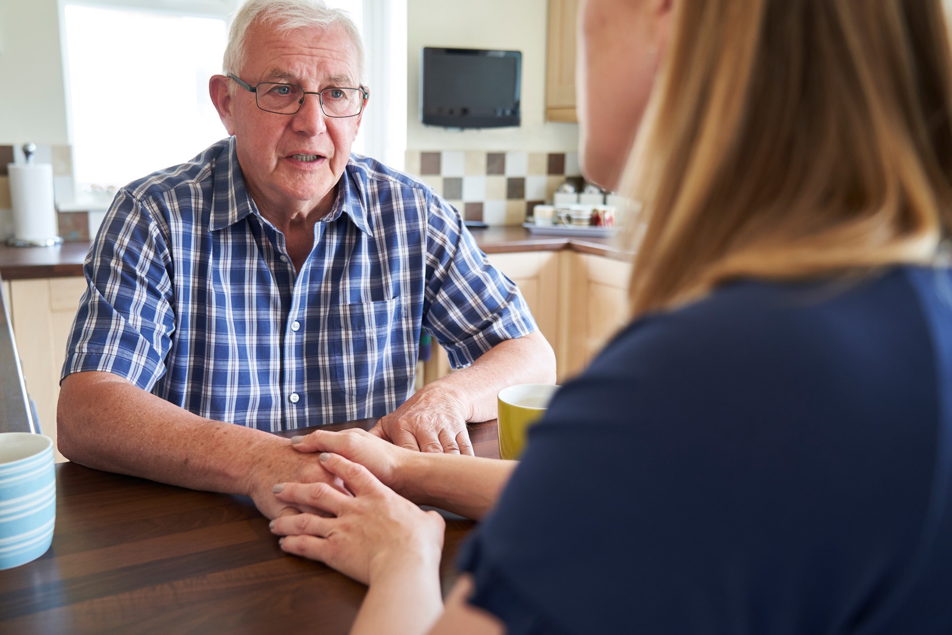 caregiver talking with older parent about long-term senior care