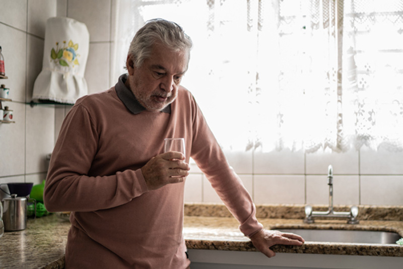 A senior man who appears depressed, offering a reminder of the link between mental health and heart health.