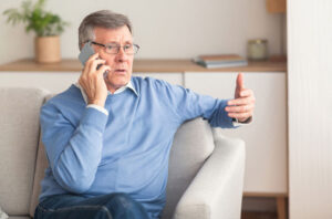 A man on the phone discusses how to stay safe from older adult scams.